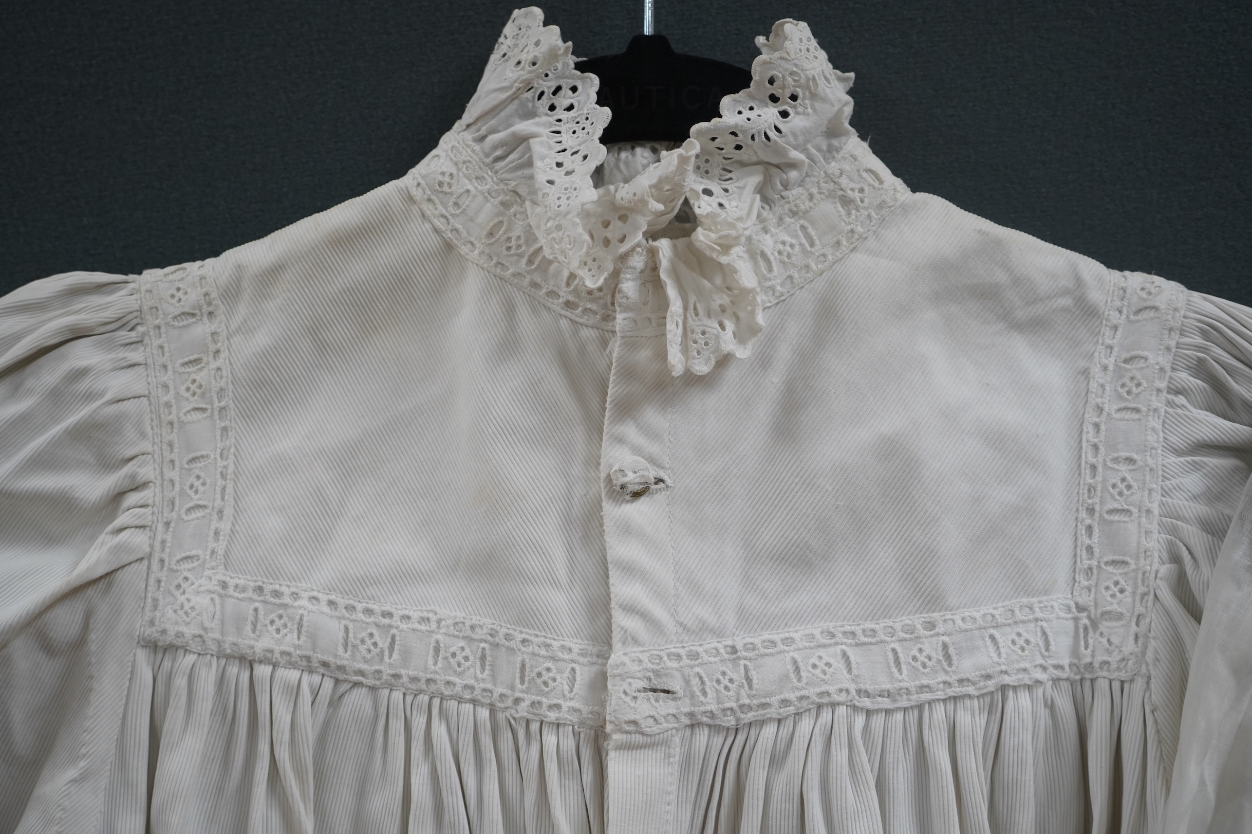 Two late 19th early 20th century girls summer dresses, one fine cotton with white worked collar cuffs and bodice, the other a cotton twill with anglaise collar large puff sleeves and gathered across the chest, lawn dress